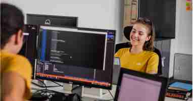 smiling woman in front of laptop