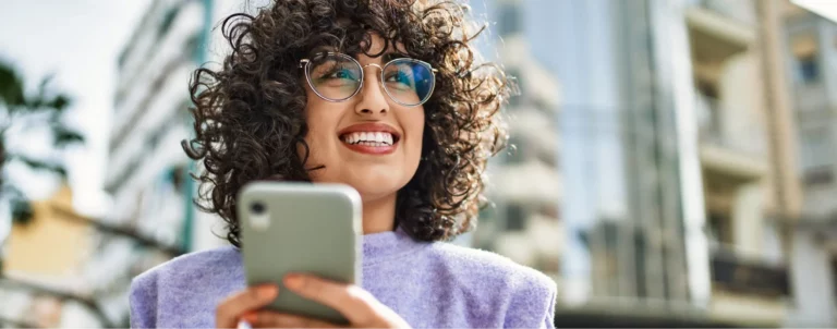 woman holding phone smiling