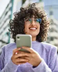 woman holding phone smiling