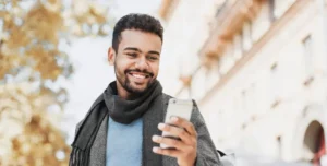 man holding phone smiling