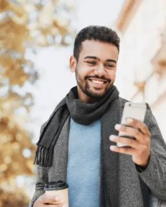 man holding phone smiling