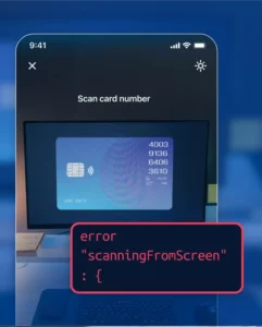 iPhone camera UI showing a monitor screen with a displayed credit card and an error message originating from the screen.
