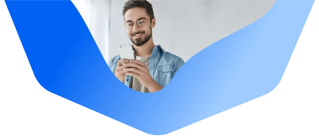 Man with glasses holding an iPhone, making an online order.