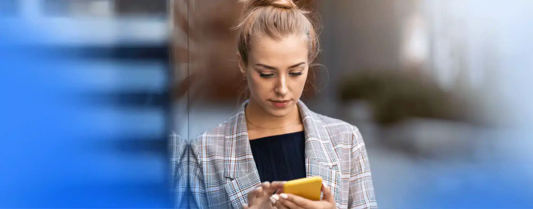User walking down the street while working on their mobile phone, showcasing multitasking on the go.