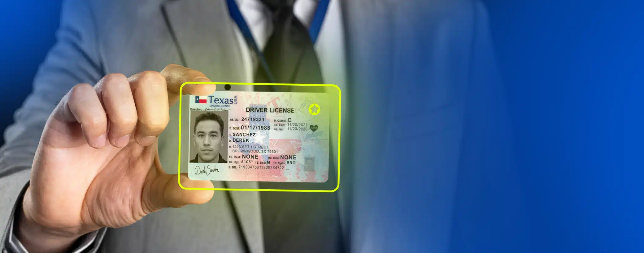a hand holding sample real ID document